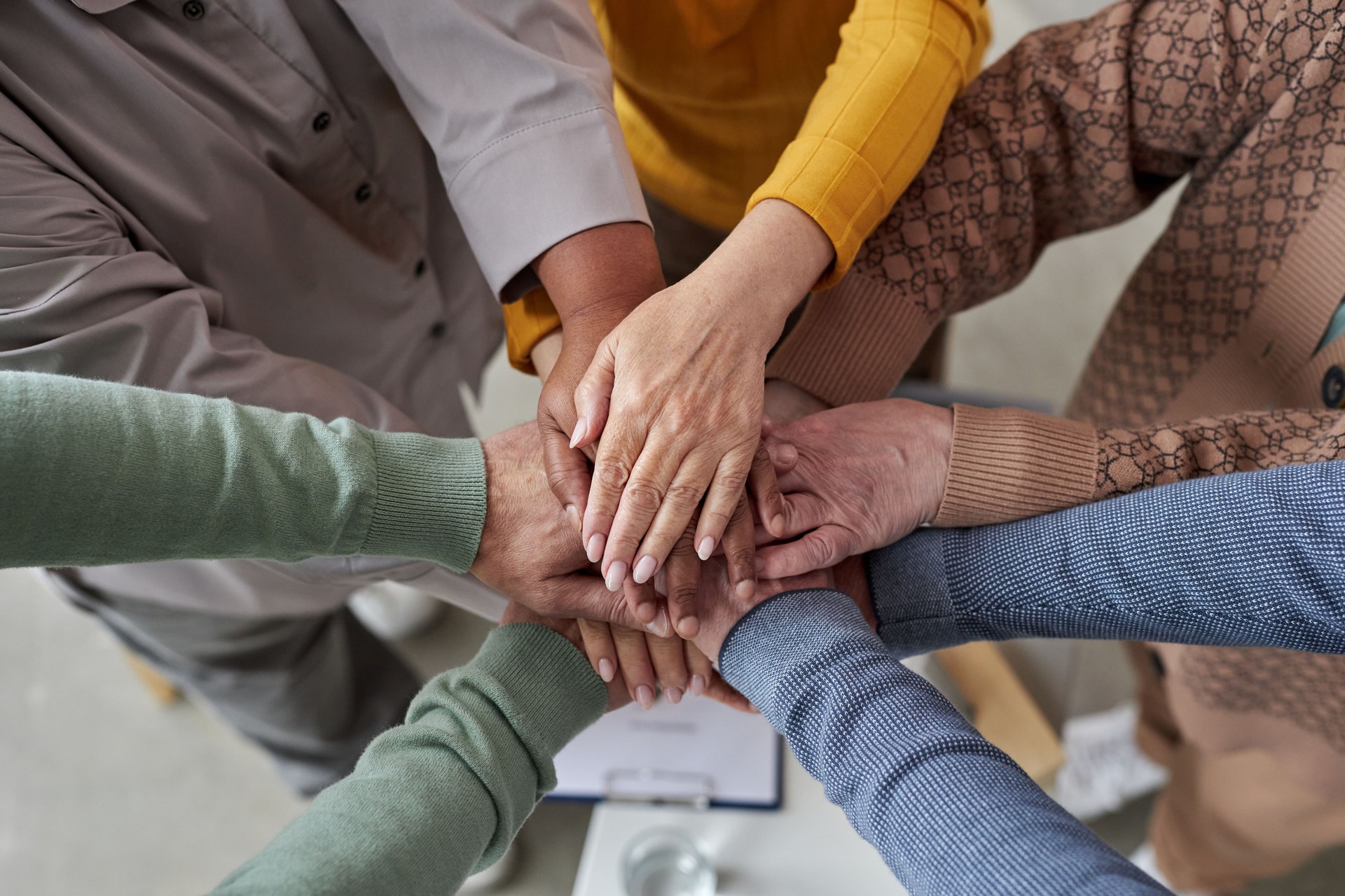 Top view up of senior people stacking hands in circle